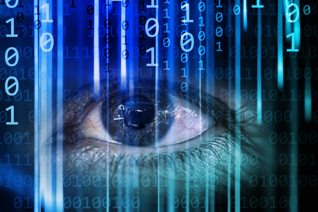 Decorative image representing human experiences of computers. An eye gazes intensely as streams of binary code cascade vertically, symbolizing the fusion of human perception with technological data processing in a futuristic digital landscape.