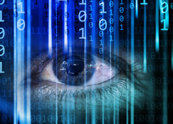 Decorative image representing human experiences of computers. An eye gazes intensely as streams of binary code cascade vertically, symbolizing the fusion of human perception with technological data processing in a futuristic digital landscape.