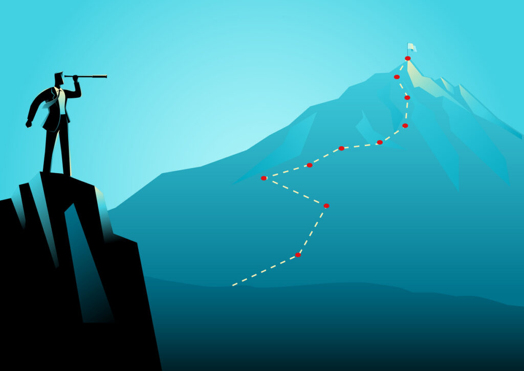 businessman on top of the rock using telescope looking to the top of a mountain