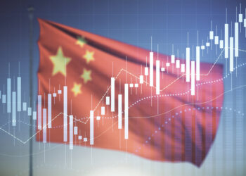 Chinese flag against a blue sky overlaid with a chart showing rising figures