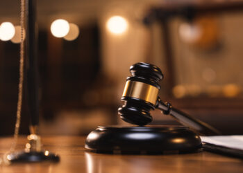 Decorative image representing court rulings: Judge gavel on the table with blurry books in the background