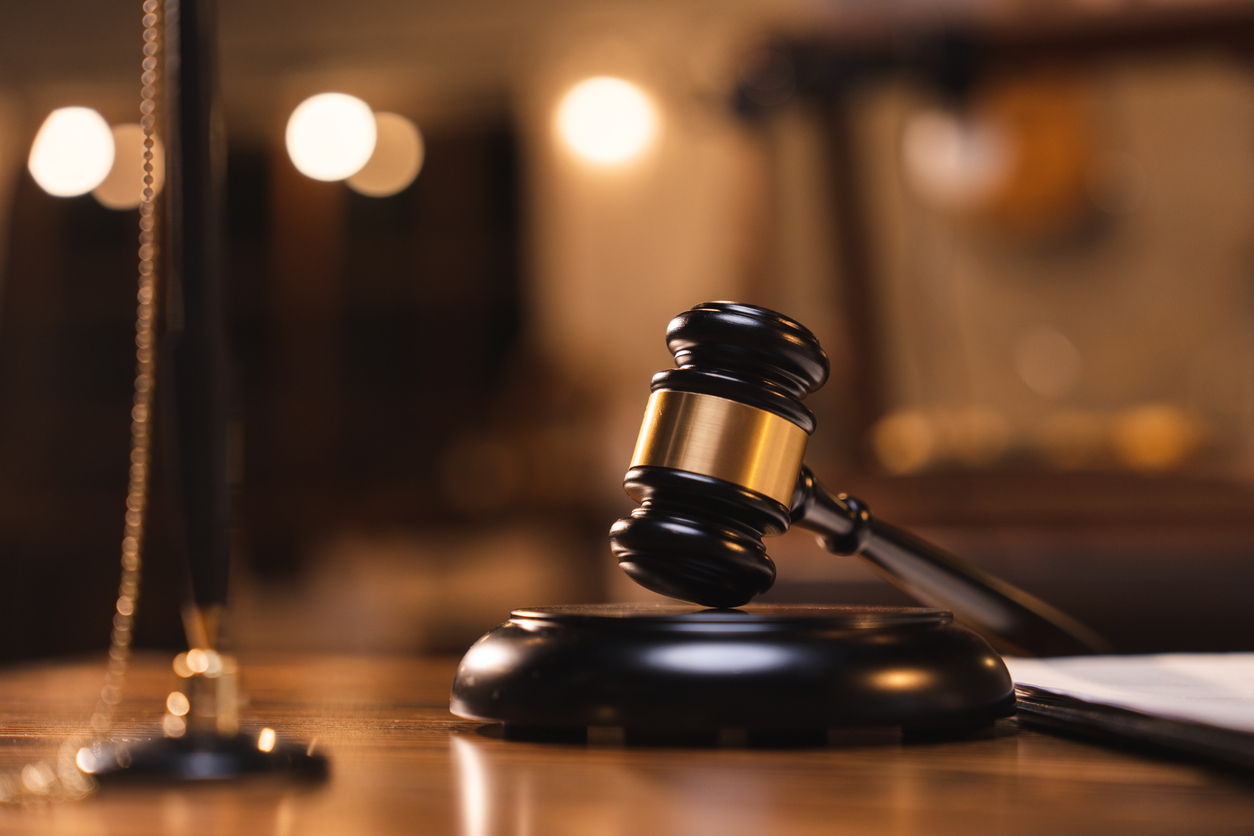 Decorative image representing court rulings: Judge gavel on the table with blurry books in the background