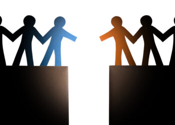 Decorative image of two groups of people approaching each other over a chasm, ready to shake hands.