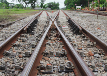 Decorative image of a railway track on gravel for train transportation