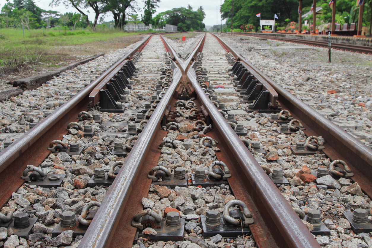 Decorative image of a railway track on gravel for train transportation