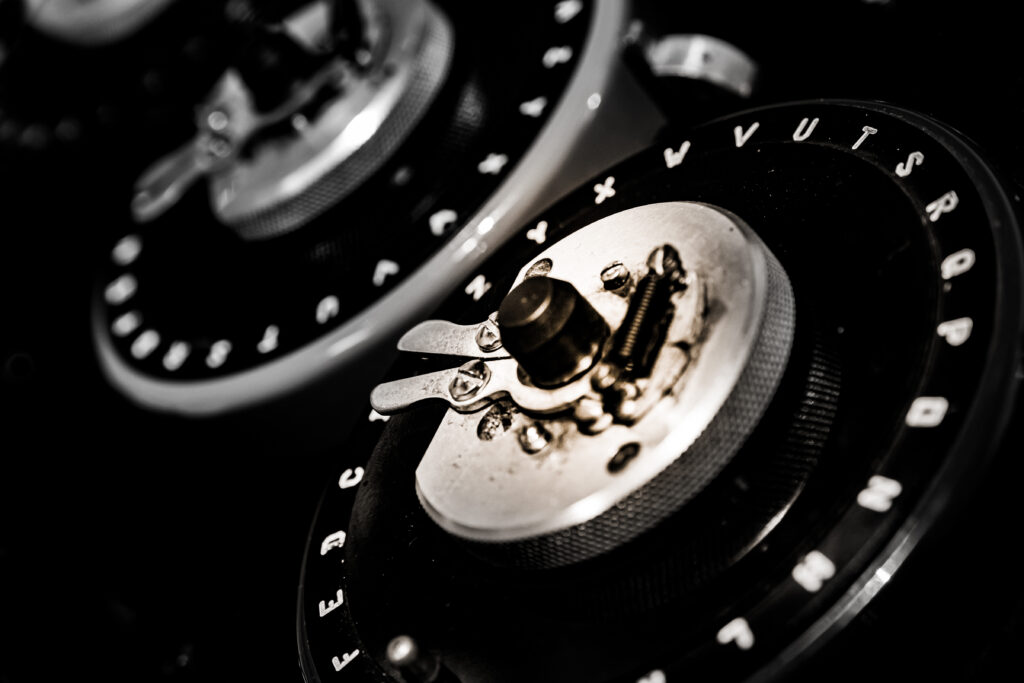 Enigma Machine gears removed from their case. There are two gears with letters on the outside in black with white letters The dials from a World War 2 'Bombe' checking machine used to crack the German 'Enigma' codes.