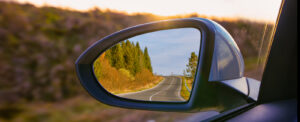 view of mountains in a car's side rear view mirror