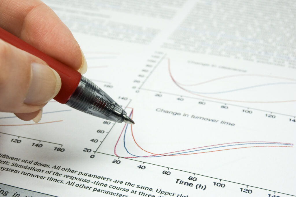 Decorative image of female hand holding hand over scientific article