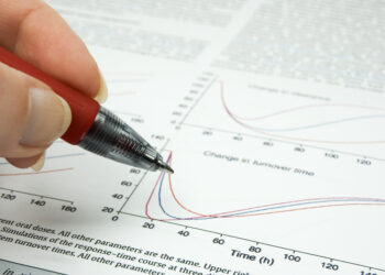 Decorative image of female hand holding hand over scientific article